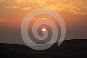 mountain silhouette in the desert at sunset sunrise