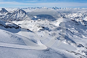 Mountain skiing - panoramic view at the ski slopes and Cervinia, Italy, Valle d`Aosta, Cervinia