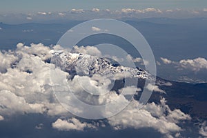 Mountain and sky from a plane window
