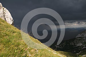 Mountain slope and dark sky