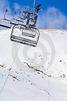 Mountain slopes with chairlift on a winter sunny day Winter mountains panorama with ski slopes and ski lifts near Brasov ski cent