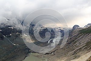 Mountain snow panorama with glacier Pasterze and clouds in High Tauern Alps, Austria