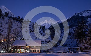 Mountain and snowfall with town house in wallpaper