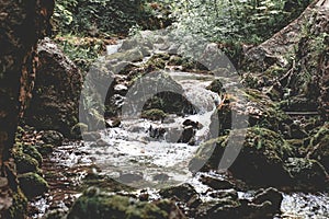 Mountain spring coming down with many waterfalls