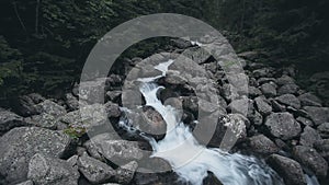 Mountain spring stream small waterfall in forest