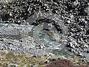 Mountain stream Aua da Grialetsch in the beautiful autumn setting of the alpine valley Val Grialetsch of the Albula Alps massif