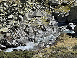 Mountain stream Aua da Grialetsch in the beautiful autumn setting of the alpine valley Val Grialetsch of the Albula Alps massif