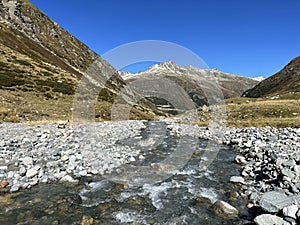 Mountain stream Aua da Grialetsch in the beautiful autumn setting of the alpine valley Val Grialetsch of the Albula Alps massif