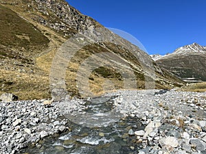 Mountain stream Aua da Grialetsch in the beautiful autumn setting of the alpine valley Val Grialetsch of the Albula Alps massif