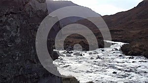 Mountain stream flowing past a derelict crofters cottage in Scotland.