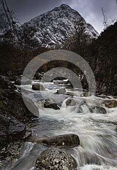 Mountain stream and snowcapped Buachille Etive Mor in autumn