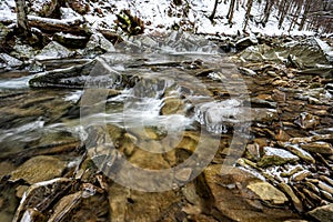 Mountain stream in winter scenery. Prowcza Stream, Bieszczady National Park, Carpathian Mountains, Poland. One of the most popular