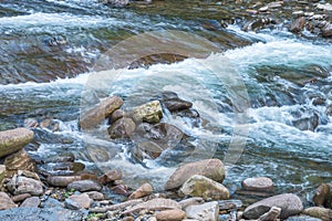 Mountain streams flowing water in the woods and atomized water