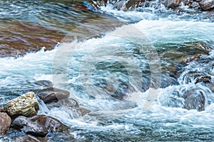 Mountain streams flowing water in the woods and atomized water