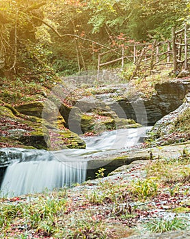 Mountain streams flowing water in the woods and atomized water photo