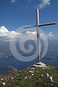 Mountain summit cross with lake view, Italy