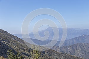 Mountain summit view with landscape of Andes and Aconcagua on clear day in La Campana National park in central Chile, South