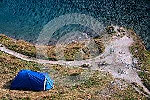 Mountain top. adventures Camping tourism and tent. landscape near water outdoor at Lacul Balea Lake, Transfagarasan, Romania.
