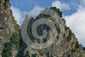 Mountain top of eagle`s rock overgrown with coniferous forest and glade of Rila mountain