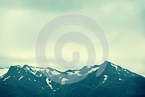 Mountain top outlined with cloudy sky