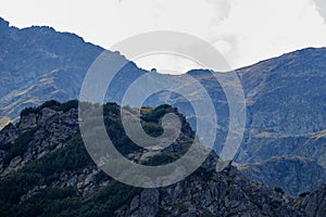 Mountain top panorama in autumn covered in mist or clouds