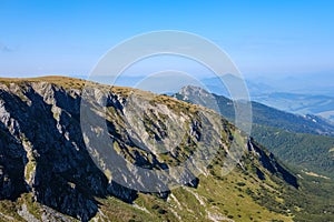 Mountain top panorama in autumn covered in mist or clouds