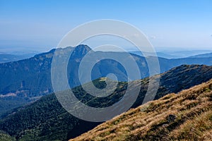 Mountain top panorama in autumn covered in mist or clouds