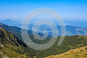 Mountain top panorama in autumn covered in mist or clouds