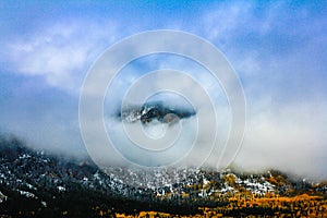 Mountain top peeking through the clouds