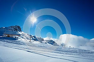 Mountain top ski lift station over alpine panorama