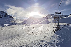 Mountain top view in winter. Ski routes, cable car in the mountains. Snowy winter mountain background.