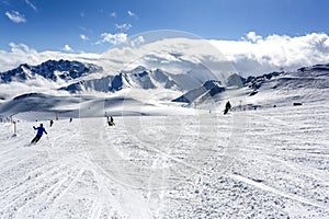 Mountain top view in winter. Ski routes in the mountains. Snowy winter mountain background.