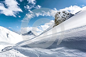 Mountain top view in winter. Ski routes in the mountains. Snowy winter mountain background.