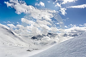 Mountain top view in winter. Ski routes in the mountains. Snowy winter mountain background.