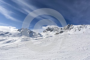 Mountain top view in winter. Ski routes in the mountains. Snowy winter mountain background.