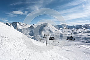 Mountain top view in winter. Ski routes in the mountains. Snowy winter mountain background.