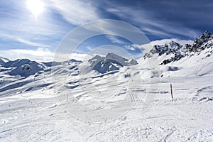 Mountain top view in winter. Ski routes in the mountains. Snowy winter mountain background.