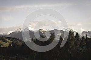 Mountain tops in autumn covered in mist or clouds - soft vintag