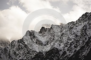 Mountain tops in autumn covered in mist or clouds - soft vintag