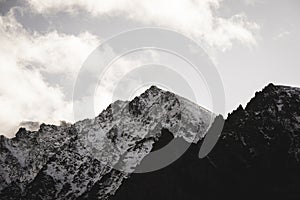 Mountain tops in autumn covered in mist or clouds - soft vintag