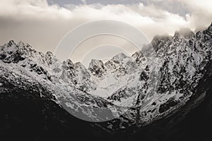 Mountain tops in autumn covered in mist or clouds - soft vintag