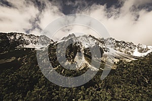 Mountain tops in autumn covered in mist or clouds - soft vintag