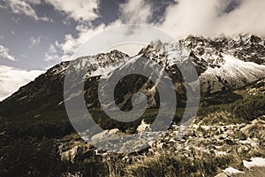 Mountain tops in autumn covered in mist or clouds - soft vintag