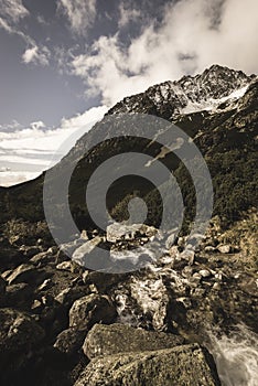 Mountain tops in autumn covered in mist or clouds - soft vintag