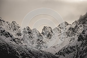 Mountain tops in autumn covered in mist or clouds - soft vintag