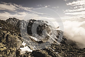 Mountain tops in autumn covered in mist or clouds - soft vintag