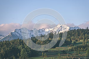 Mountain tops in autumn covered in mist or clouds in sunny day-