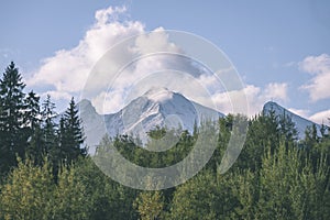 Mountain tops in autumn covered in mist or clouds in sunny day-