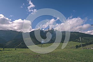 Mountain tops in autumn covered in mist or clouds in sunny day-