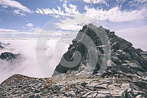 Mountain tops in autumn covered in mist or clouds- vintage effe